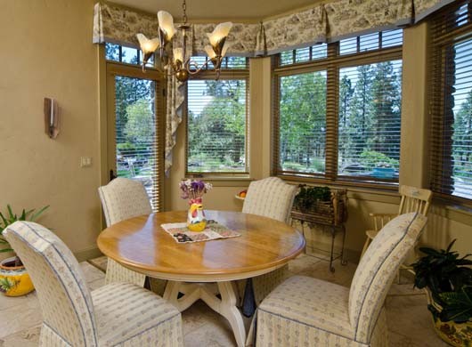 This modern dining room has tile floors and a beautiful setting.